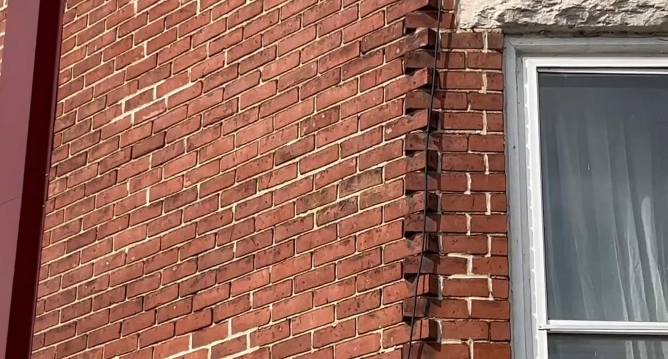 Professional brick repair and restoration services showing damaged brick corner before repair in Springfield, MO