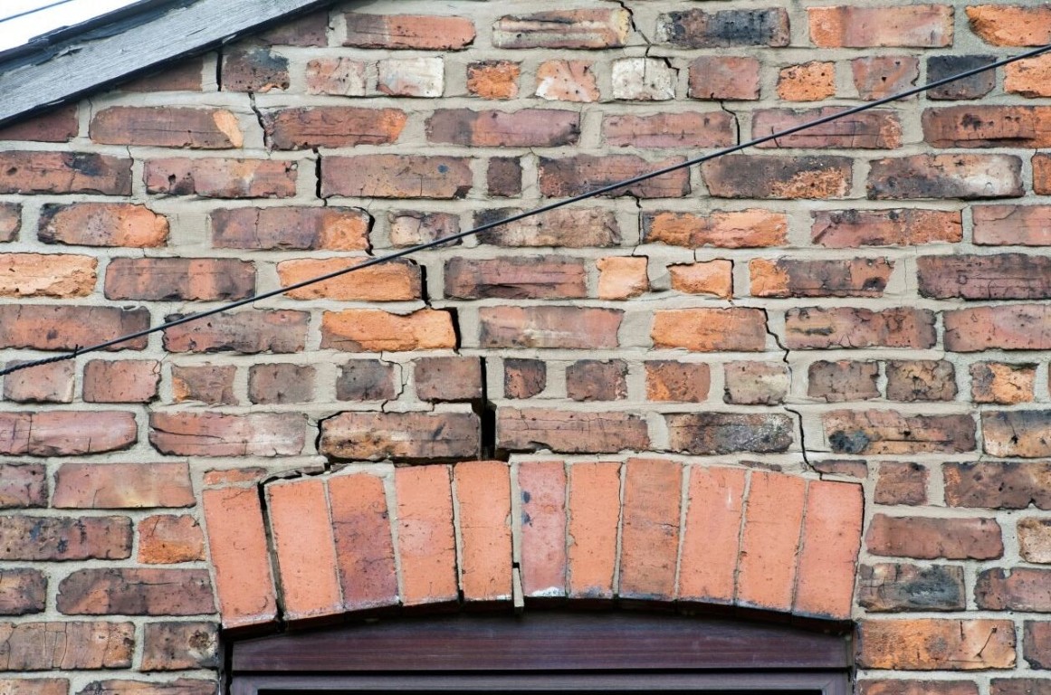 Cracked brick wall showing structural damage requiring foundation repair in Springfield, MO