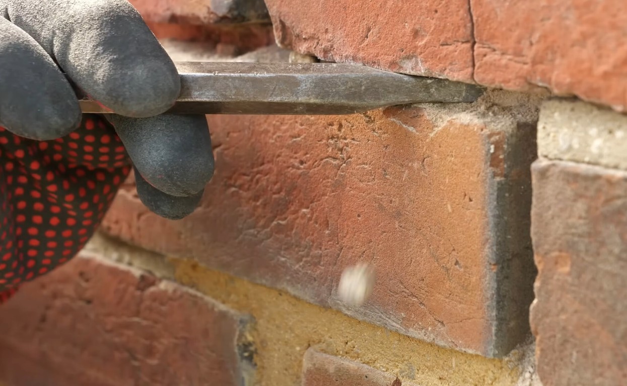 Professional tuckpointing and repointing services being performed on brick wall in Springfield, MO